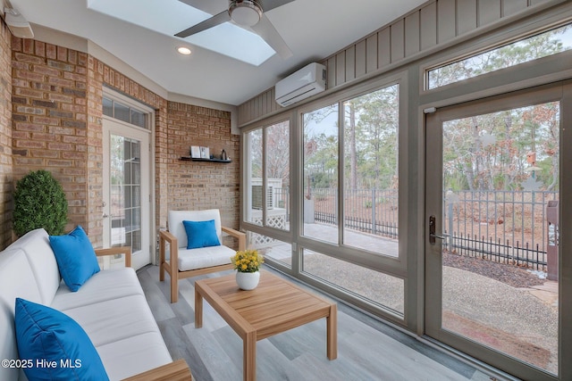 sunroom featuring ceiling fan and a wall mounted air conditioner