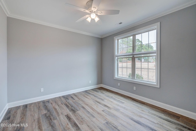 empty room with ceiling fan, ornamental molding, and light hardwood / wood-style floors