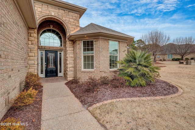 property entrance with a yard