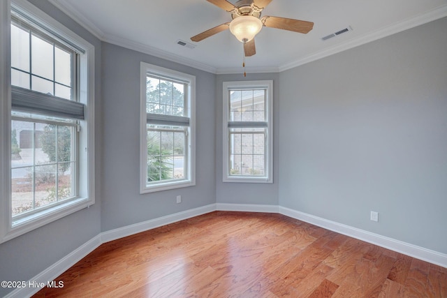 spare room featuring ceiling fan, light wood-type flooring, and ornamental molding