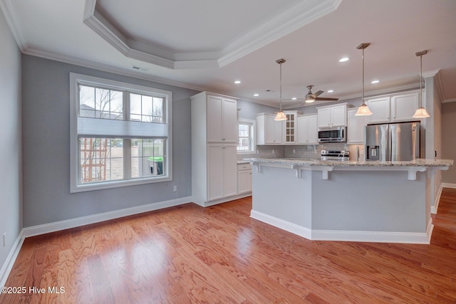 kitchen featuring ceiling fan, appliances with stainless steel finishes, decorative light fixtures, crown molding, and white cabinets