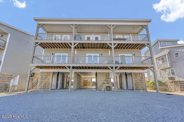 view of front of home featuring a carport and a balcony