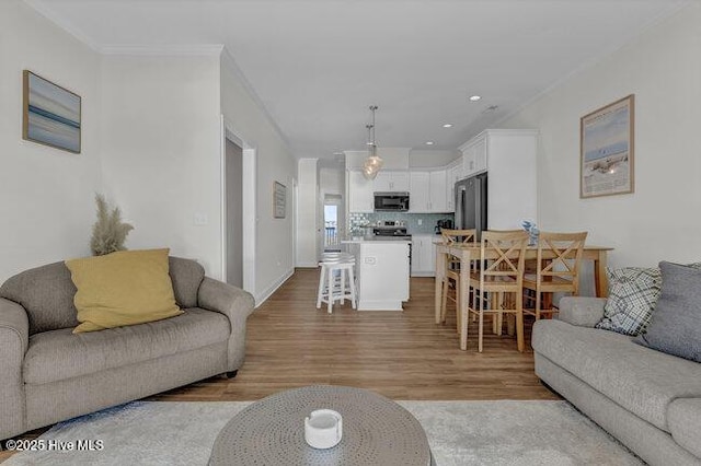 1788 New River Inlet Rd, North Topsail Beach, NC 28460 - living area with light wood finished floors, ornamental molding, and recessed lighting