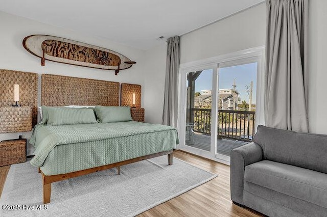 1788 New River Inlet Rd, North Topsail Beach, NC 28460 - bedroom with access to outside and wood finished floors