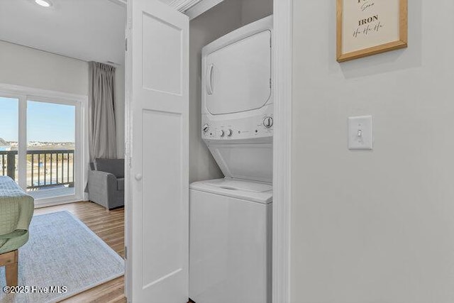 1788 New River Inlet Rd, North Topsail Beach, NC 28460 - washroom featuring stacked washer / dryer and wood finished floors