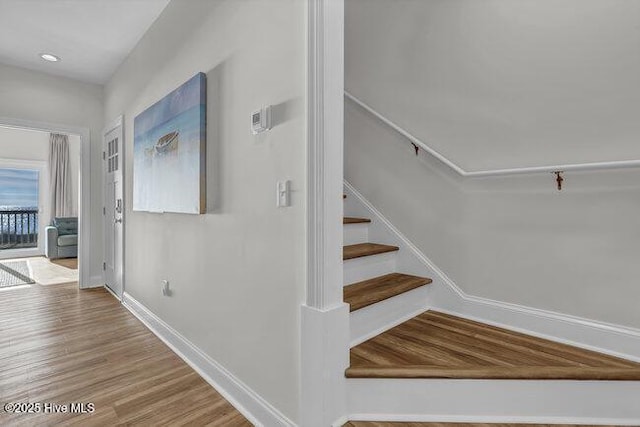 1788 New River Inlet Rd, North Topsail Beach, NC 28460 - stairway with baseboards and wood finished floors
