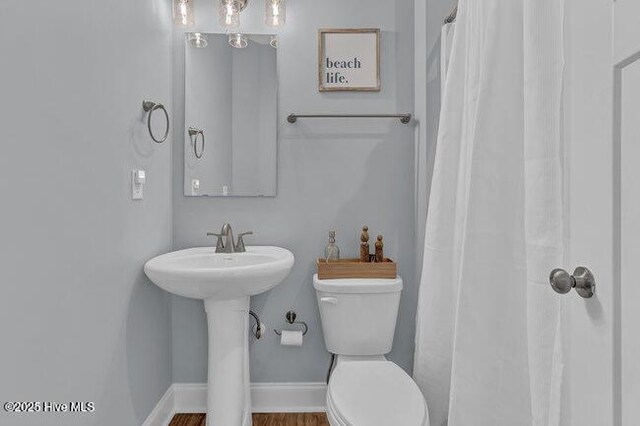 1788 New River Inlet Rd, North Topsail Beach, NC 28460 - bathroom with a shower with curtain and wood finished floors