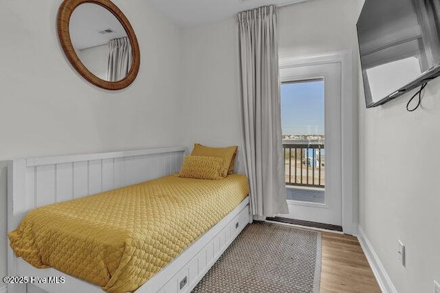 1788 New River Inlet Rd, North Topsail Beach, NC 28460 - bedroom with access to exterior and light wood-style floors