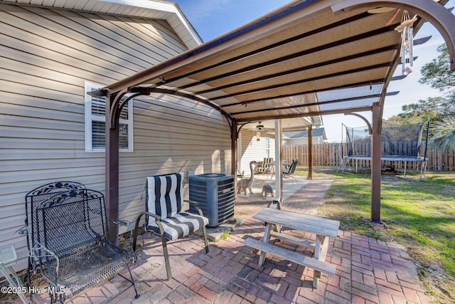 view of patio / terrace featuring a pergola, cooling unit, and a trampoline