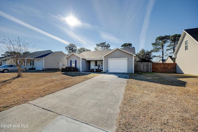 ranch-style home with a garage and a front lawn