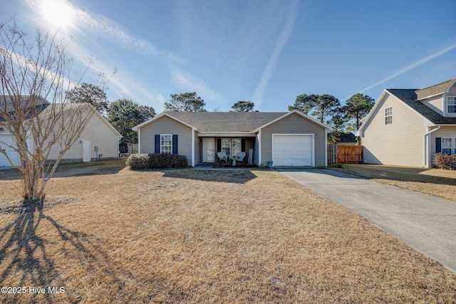 view of front of property featuring a garage, a front lawn, and covered porch