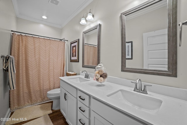 bathroom featuring hardwood / wood-style floors, a shower with curtain, toilet, vanity, and crown molding