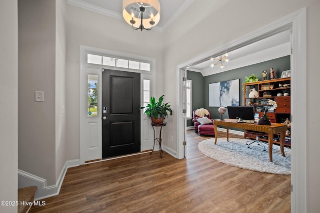 foyer entrance with an inviting chandelier, hardwood / wood-style floors, and ornamental molding