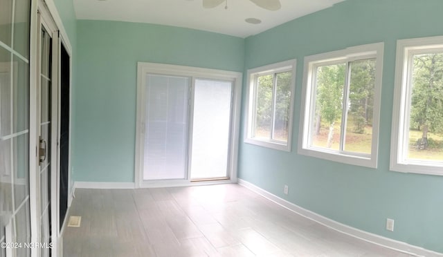 unfurnished sunroom featuring ceiling fan