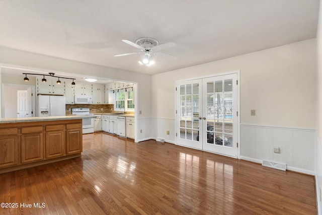 kitchen with sink, french doors, white appliances, hardwood / wood-style floors, and ceiling fan