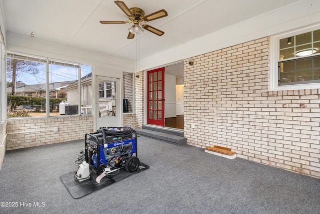 unfurnished sunroom with ceiling fan