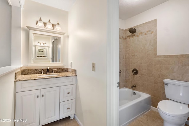 full bathroom with tile walls, toilet, tile patterned floors, vanity, and tiled shower / bath combo