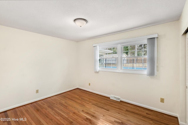 empty room with wood-type flooring