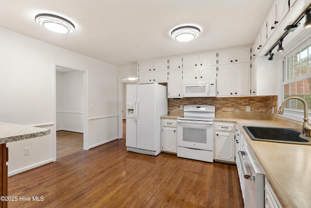 kitchen with white appliances, dark hardwood / wood-style flooring, white cabinets, backsplash, and sink