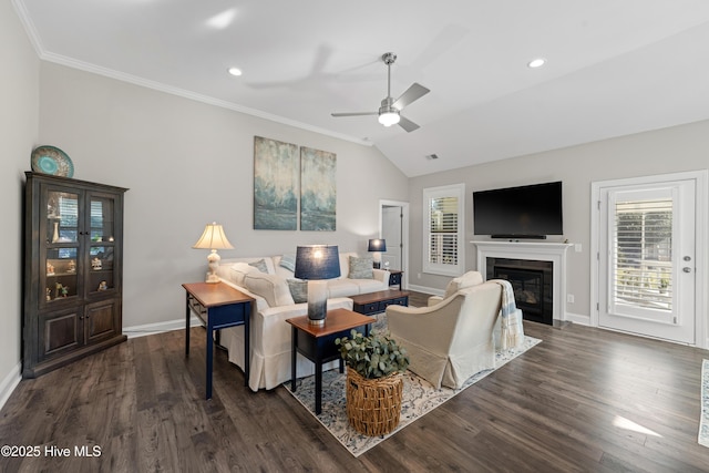 living room with dark wood-type flooring, ornamental molding, lofted ceiling, and ceiling fan