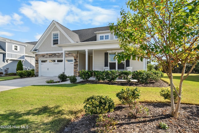 craftsman inspired home with a front yard, covered porch, and a garage