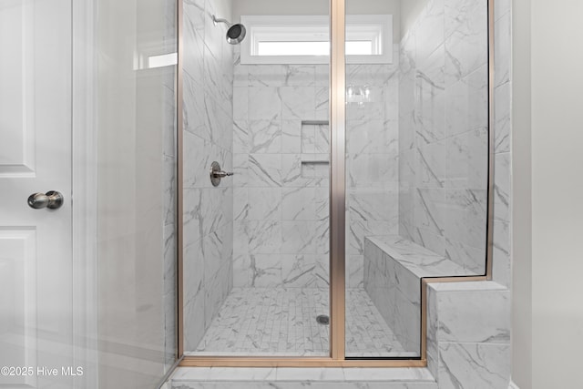 bathroom featuring a shower with shower door