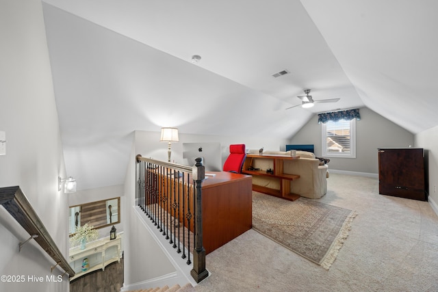 interior space featuring light carpet, ceiling fan, and lofted ceiling