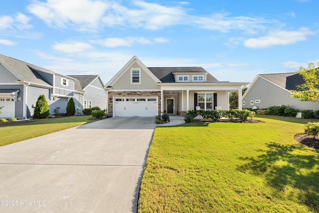 view of front of house with a front lawn, covered porch, and a garage