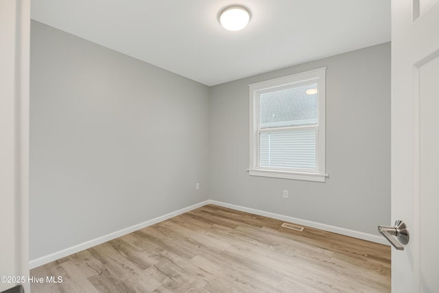 spare room featuring light hardwood / wood-style floors