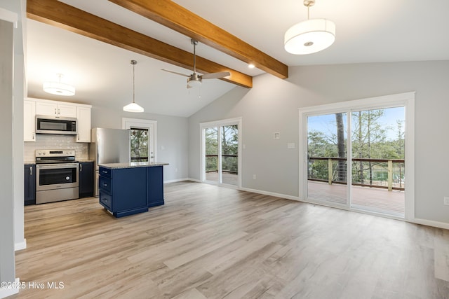 11 White Ln, Oak Island, NC 28465 - kitchen featuring appliances with stainless steel finishes, blue cabinetry, light wood-style floors, backsplash, and a ceiling fan