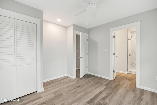 unfurnished bedroom featuring connected bathroom, light hardwood / wood-style flooring, a closet, and ceiling fan