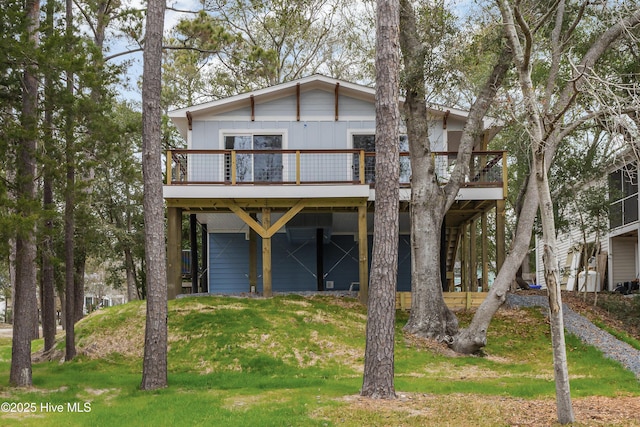 rear view of house with a deck and a lawn