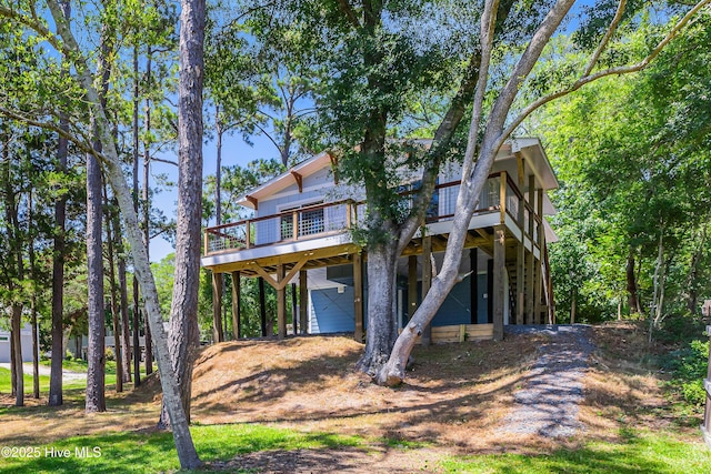 11 White Ln, Oak Island, NC 28465 - rear view of house with a wooden deck