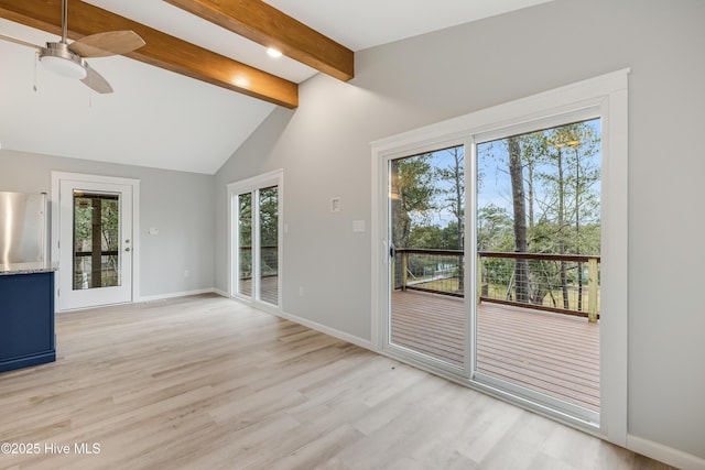 unfurnished living room featuring vaulted ceiling with beams, light hardwood / wood-style floors, and ceiling fan