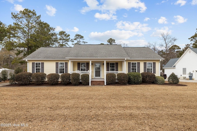 single story home featuring a porch and a front lawn