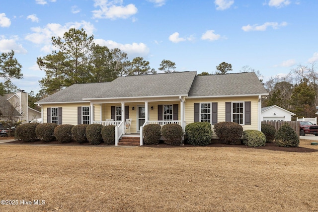 ranch-style house with covered porch and a front lawn