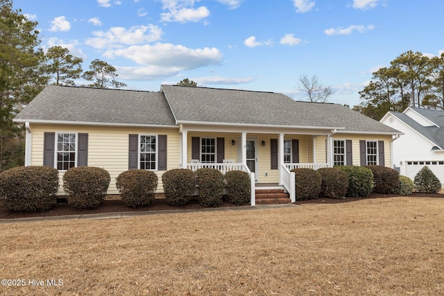 ranch-style home with covered porch, a garage, and a front lawn