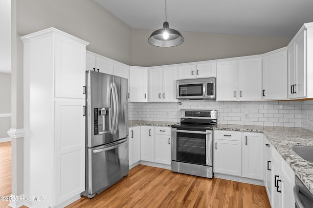 kitchen with backsplash, white cabinetry, hanging light fixtures, and appliances with stainless steel finishes