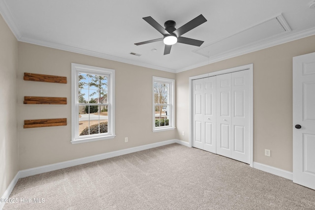 unfurnished bedroom with carpet, a closet, ceiling fan, and ornamental molding