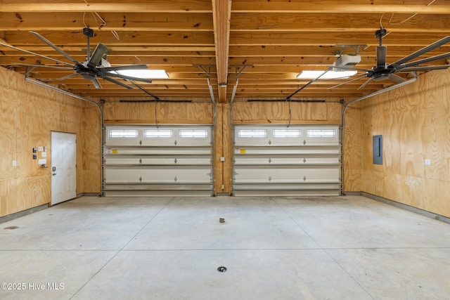 garage with electric panel, wooden walls, and a garage door opener