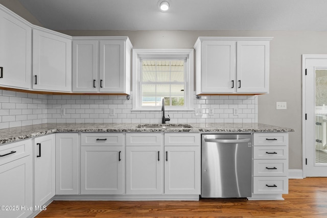 kitchen with sink, white cabinetry, dishwasher, and tasteful backsplash