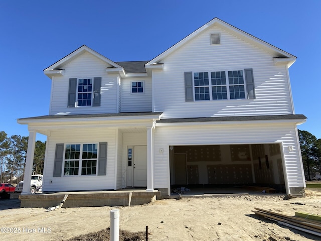 view of front facade with a garage and a porch