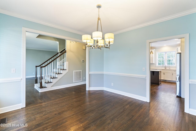 interior space with ornamental molding, an inviting chandelier, and dark hardwood / wood-style flooring