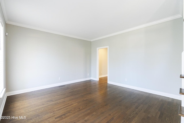 spare room featuring crown molding and dark hardwood / wood-style floors