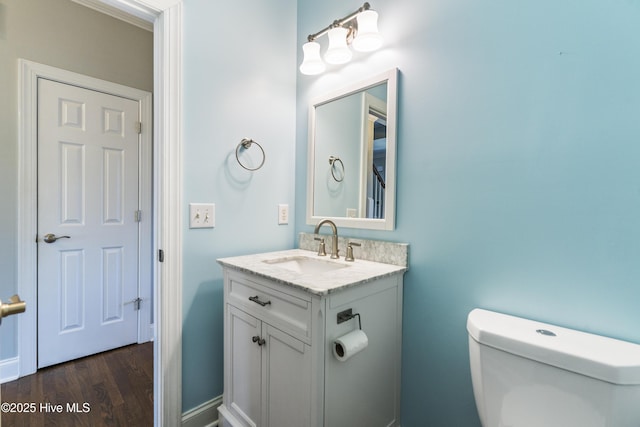 bathroom featuring hardwood / wood-style flooring, vanity, and toilet