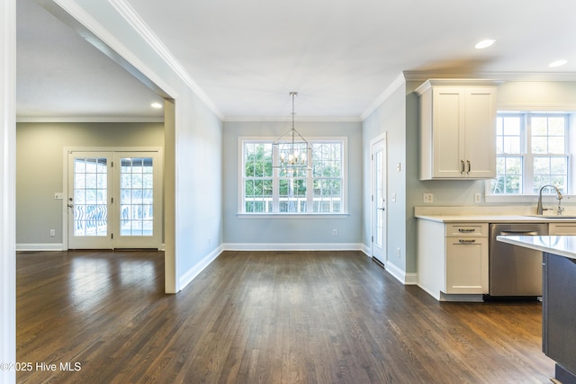 kitchen with white cabinetry, dishwasher, plenty of natural light, and decorative light fixtures