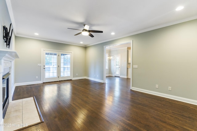 unfurnished living room featuring crown molding, dark hardwood / wood-style floors, and ceiling fan with notable chandelier