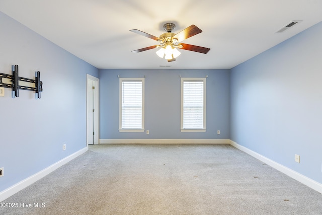 carpeted empty room featuring ceiling fan