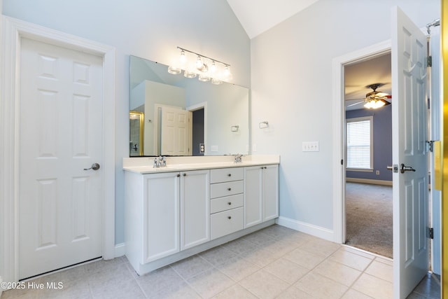 bathroom with ceiling fan, lofted ceiling, tile patterned flooring, and vanity