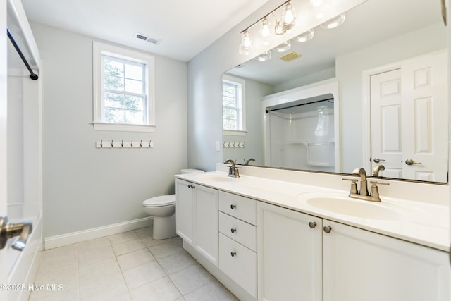 bathroom with vanity, tile patterned floors, toilet, and walk in shower